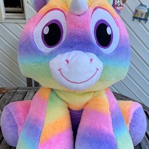 Peek a boo rainbow unicorn plush toy.
